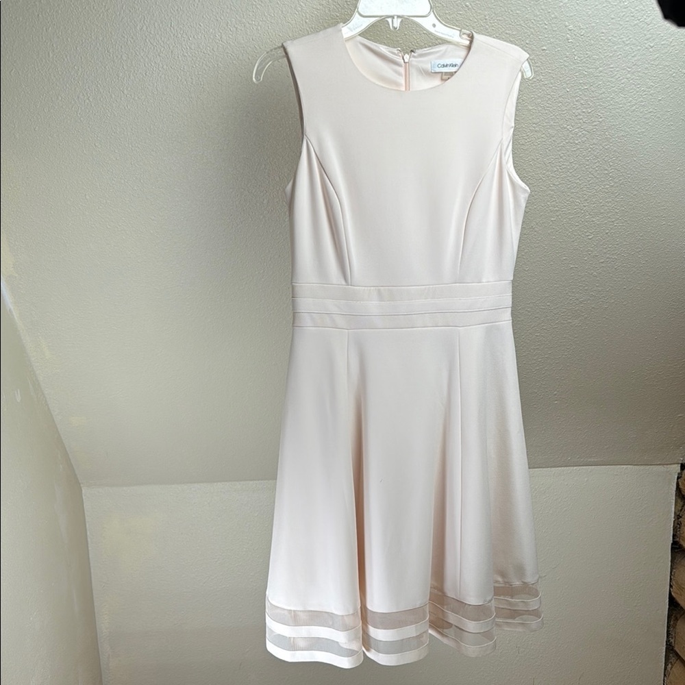 Calvin Klein Fit and Flair dress. Pale Pink. Size 8. Cute Peek-a-boo hemline.